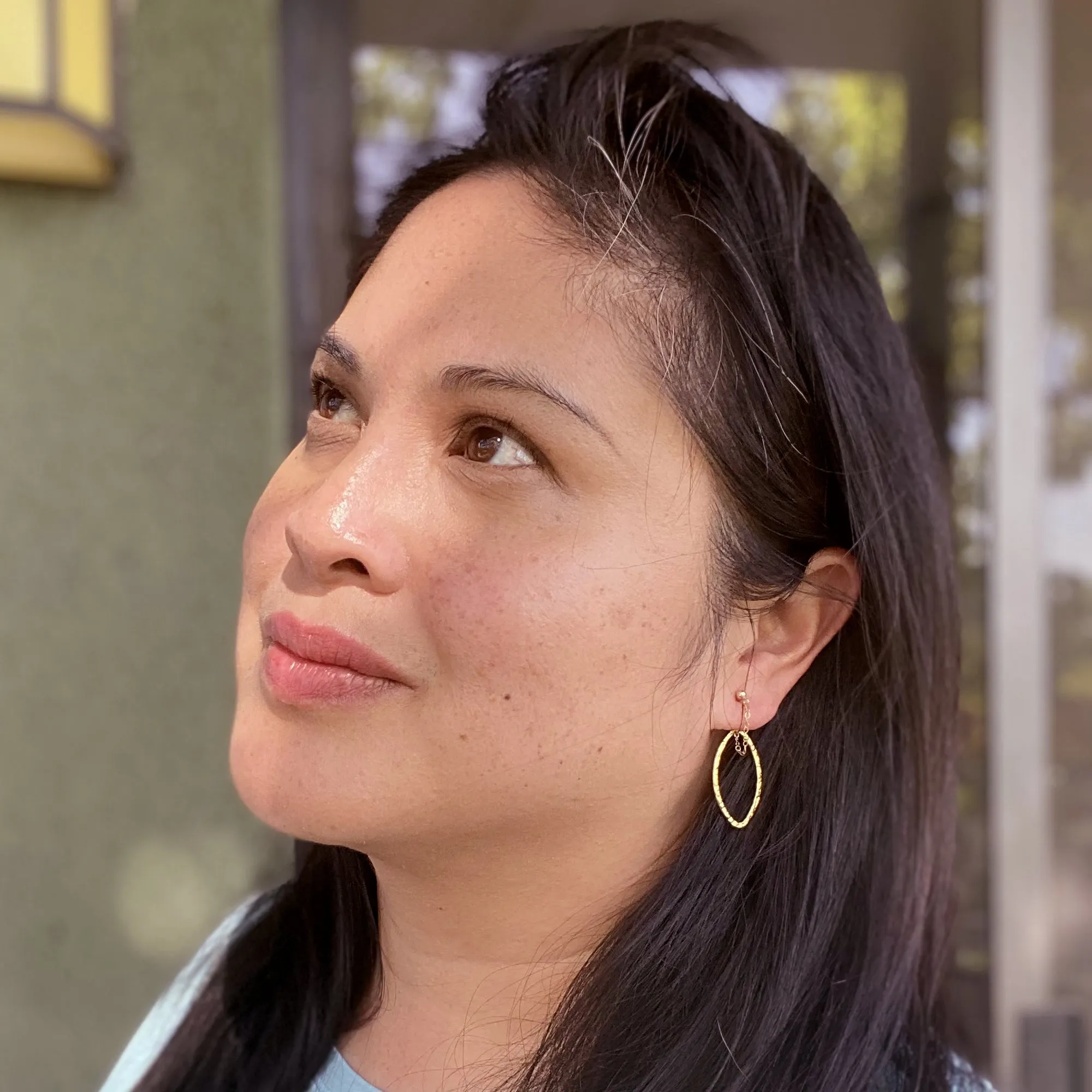 Gold saturn earrings in hammered