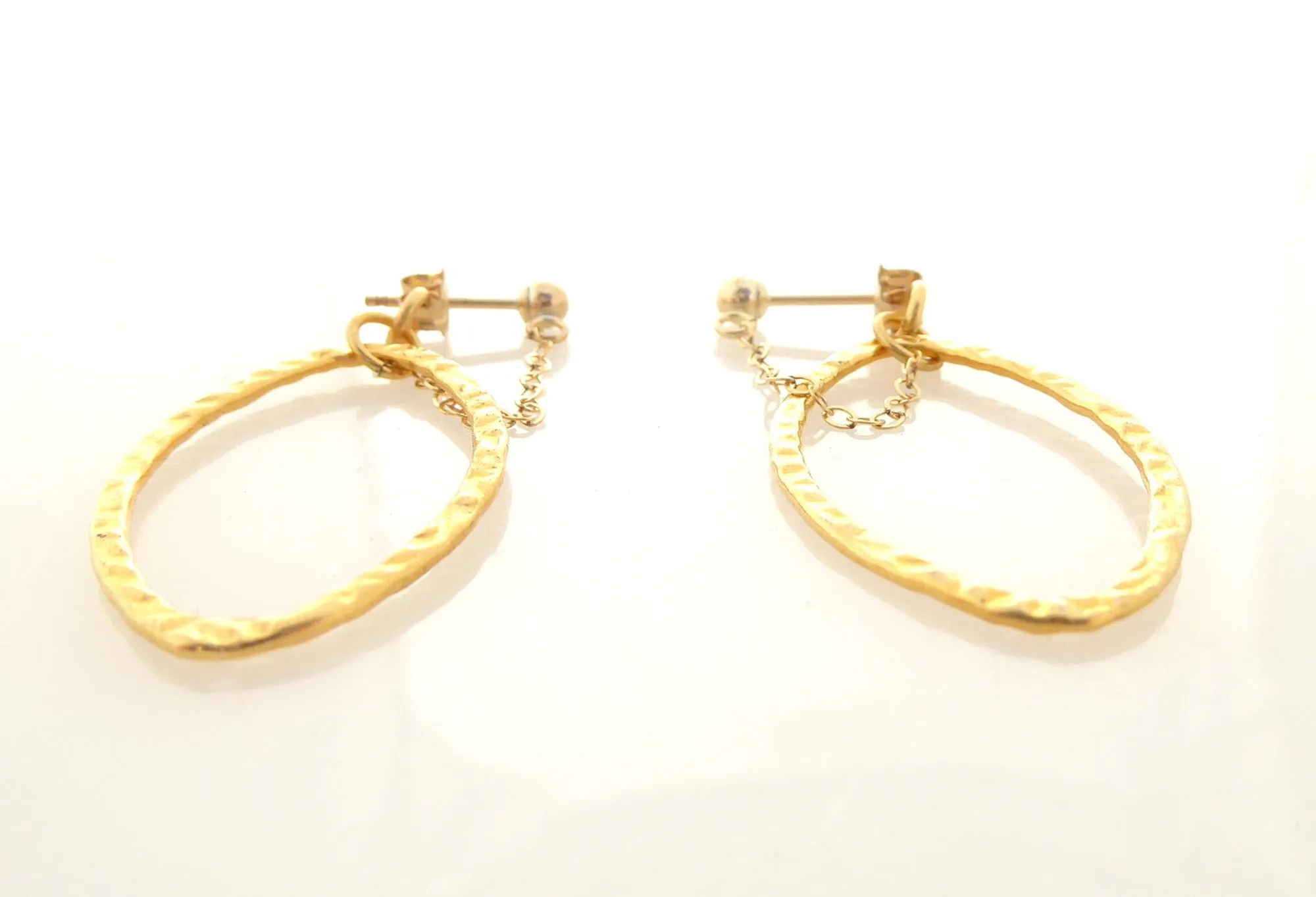 Gold saturn earrings in hammered