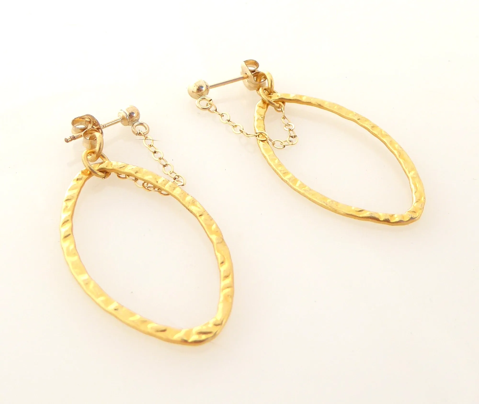 Gold saturn earrings in hammered