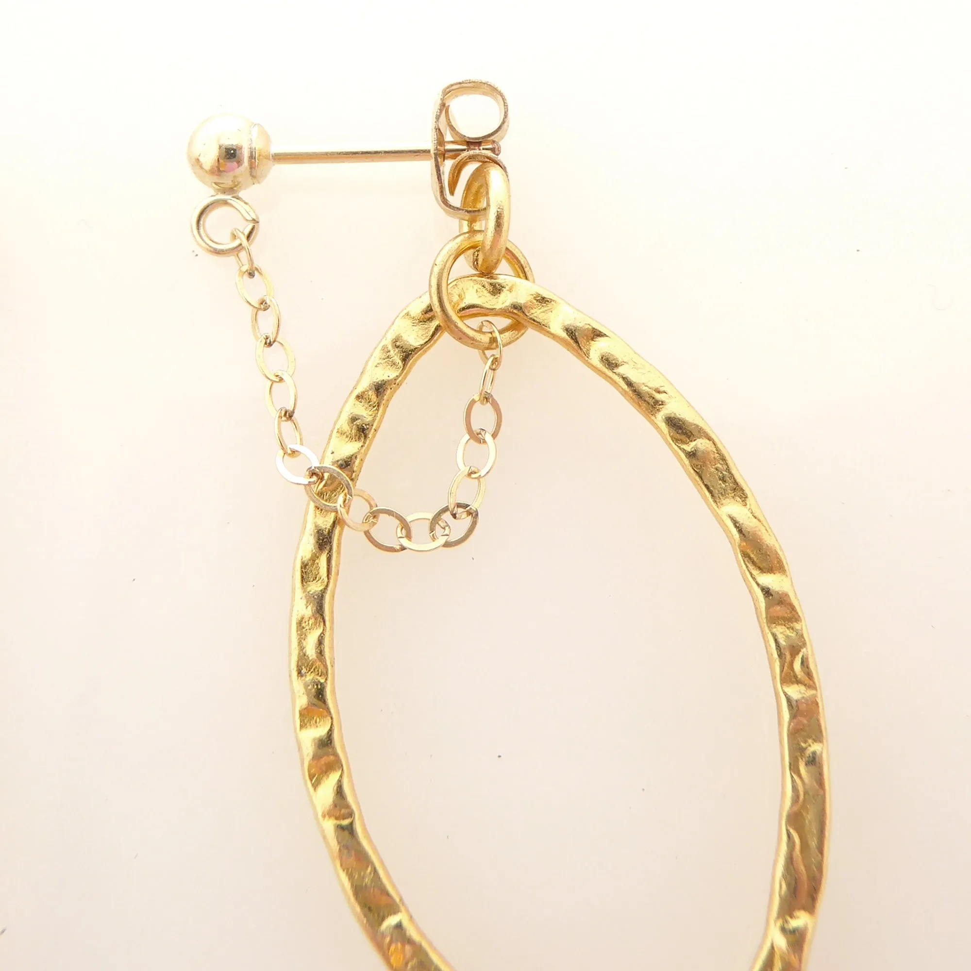 Gold saturn earrings in hammered